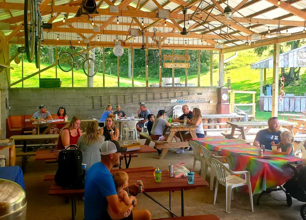 People eating at picnic tables.