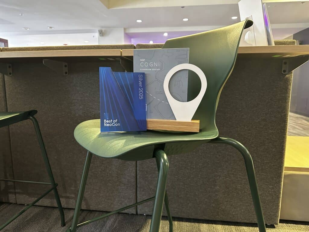 A green chair with a book on it and a blue plaque.