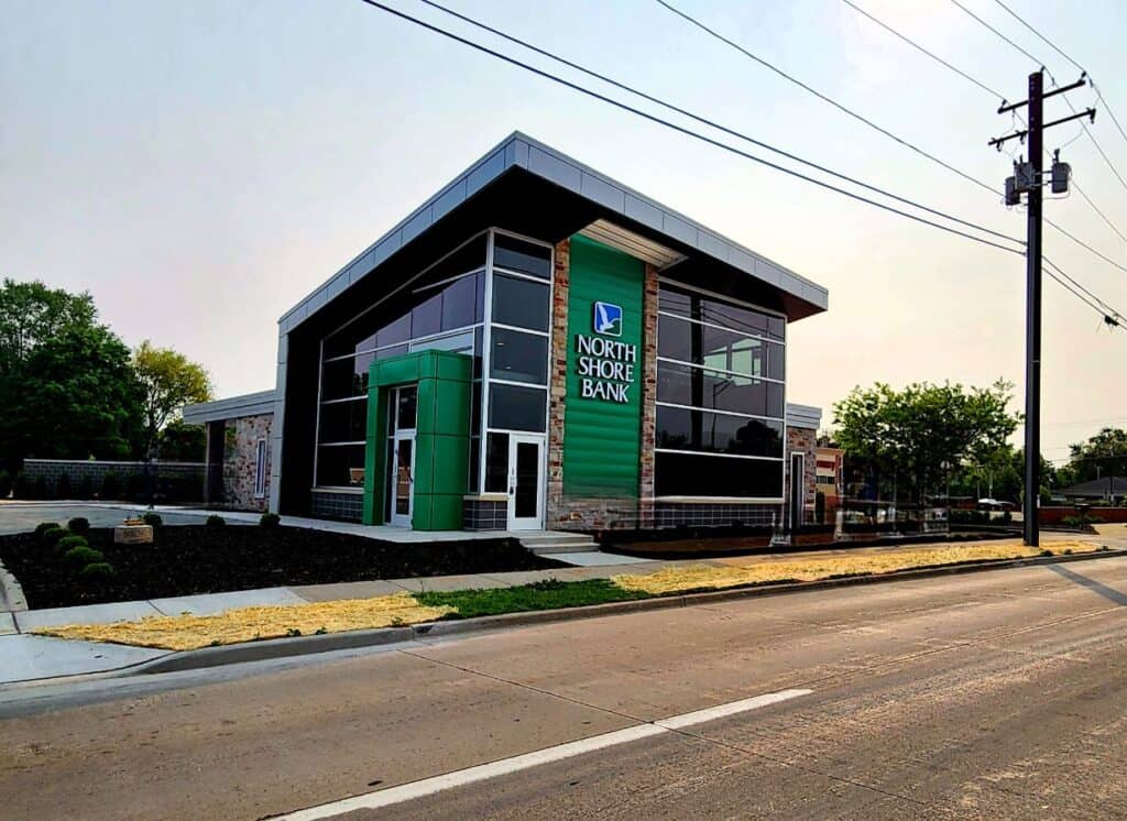 A green building with a sign that says "North Shore Bank."