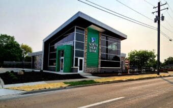 A green building with a sign that says "North Shore Bank."