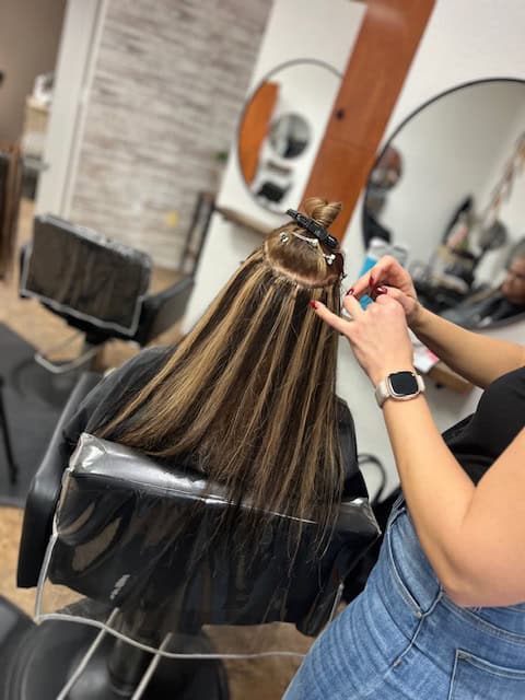 A woman getting her hair done at a salon.