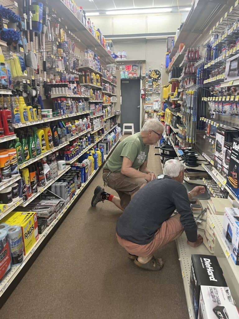 Two men looking at items in a store.