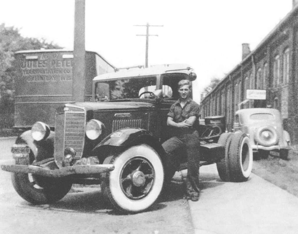 A man standing next to a truck.