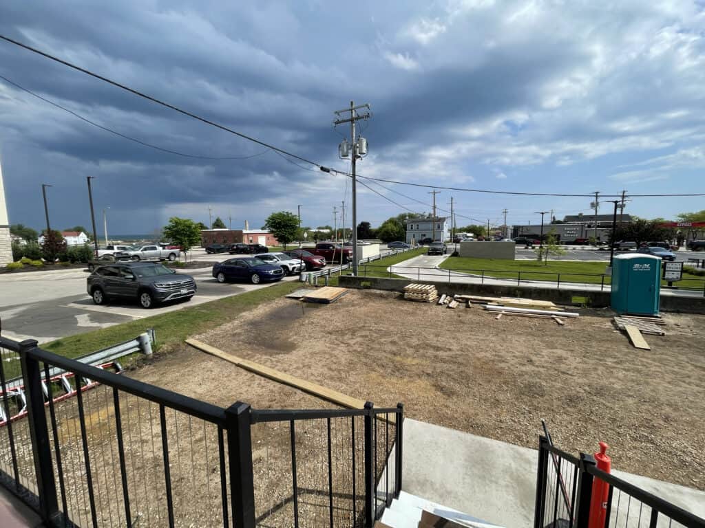 A view of the parking lot and backyard from a building.